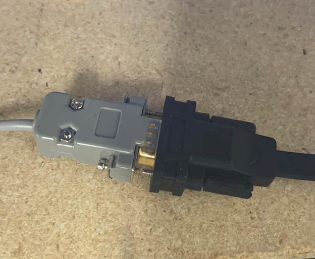 A grey and black electrical plugAI-generated content may be incorrect.