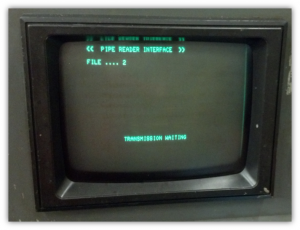 A small black rectangular tv with green textDescription automatically generated with medium confidence